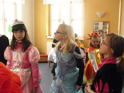 Zwei Mädchen tragen edle Kleider wie Märchenprinzessinnen.