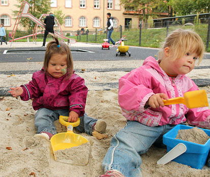 Zwei Mädchen spielen im Sandkasten